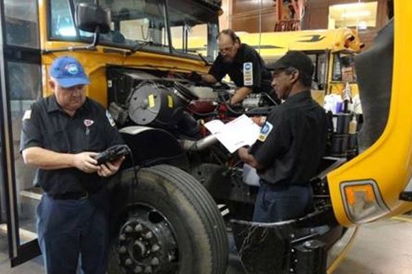 mechanics working on a bus